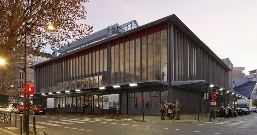 Recreación de la fachada rehabilitada de la Maison du Peuple de Clichy para Ducasse Paris al anochecer, con muros cortina de vidrio